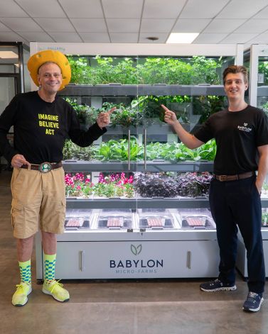 Stephen Ritz and Alexander Olesen Stand in front of a Galleri Micro-Farm